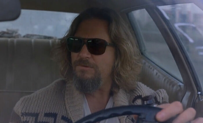 Man with sunglasses driving a car, embodying an iconic movie scene that took years for viewers to fully understand.