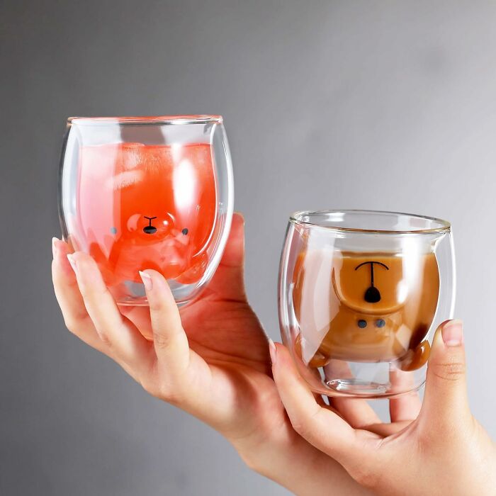 Two double-walled glasses with cute bear shapes inside, filled with colorful drinks, showcasing peak coolness design.