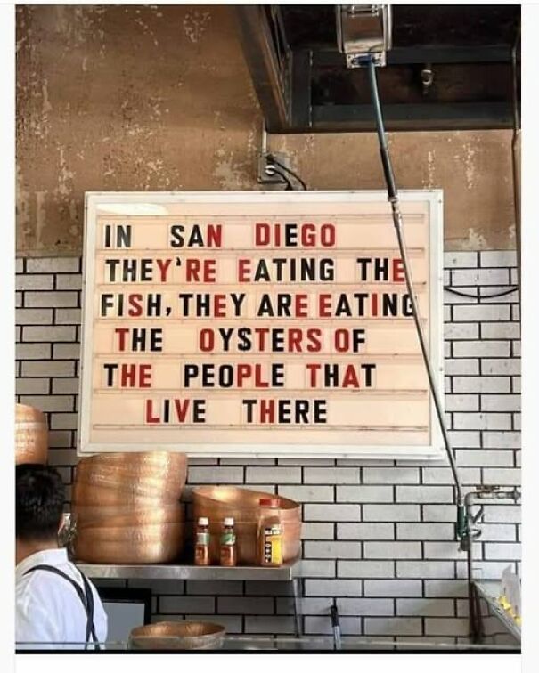 Weird sign in a San Diego restaurant with humorous text about eating fish and oysters.