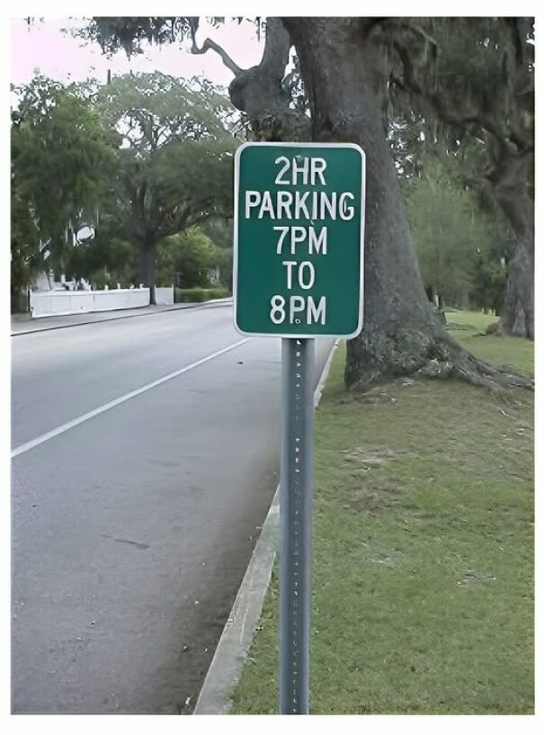 Weird and absurd parking sign allowing 2-hour parking from 7 PM to 8 PM seen on a roadside.