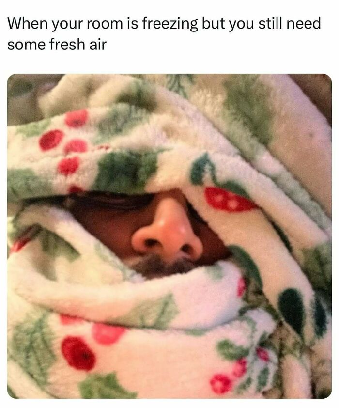 Person wrapped in a floral blanket, nose and eyes barely visible, illustrating relatable memes about needing fresh air despite cold.