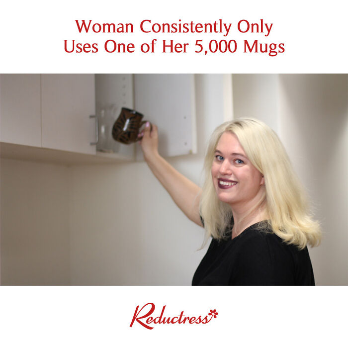 Blonde woman humorously uses same mug from a cabinet full of cups.