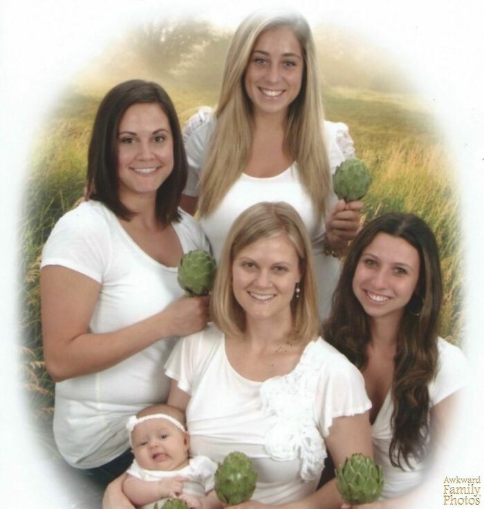 Family photo with four women and a baby, all holding artichokes, outdoors in a field, showcasing awkward family moments.