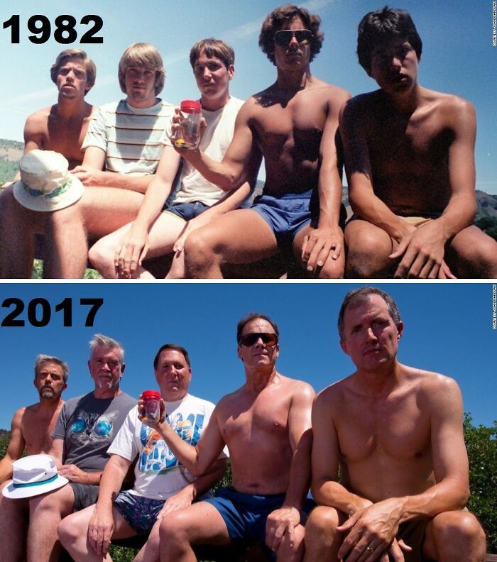 Men recreate a wholesome family photo from 1982 to 2017, seated outdoors and holding a jar.