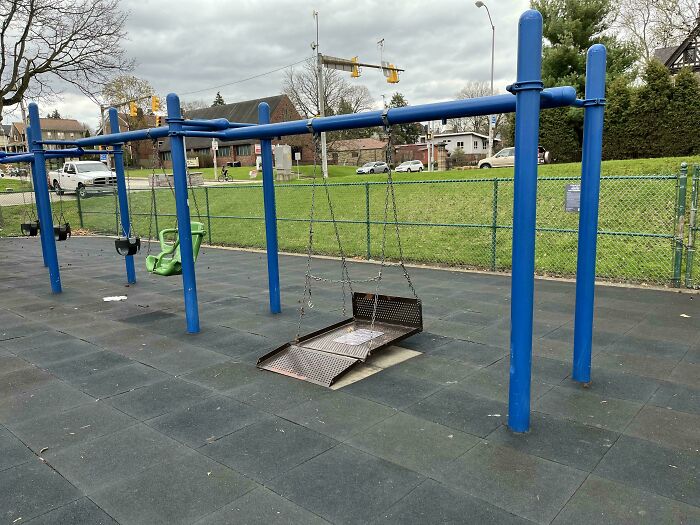 Accessible swing in playground showing someone having another's back in a wholesome way.