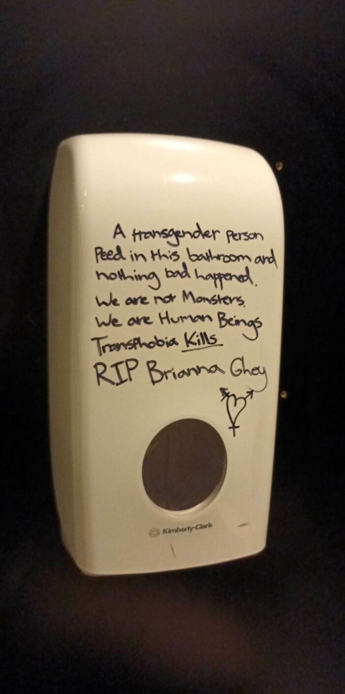 Bathroom dispenser with supportive message, highlighting trans rights and remembering Brianna Ghey.