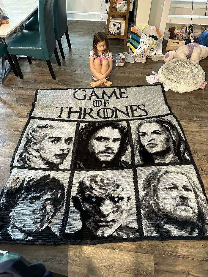 Child sitting near a handmade Game of Thrones quilt; a thoughtful Amazing-Mothers-In-Law gift.