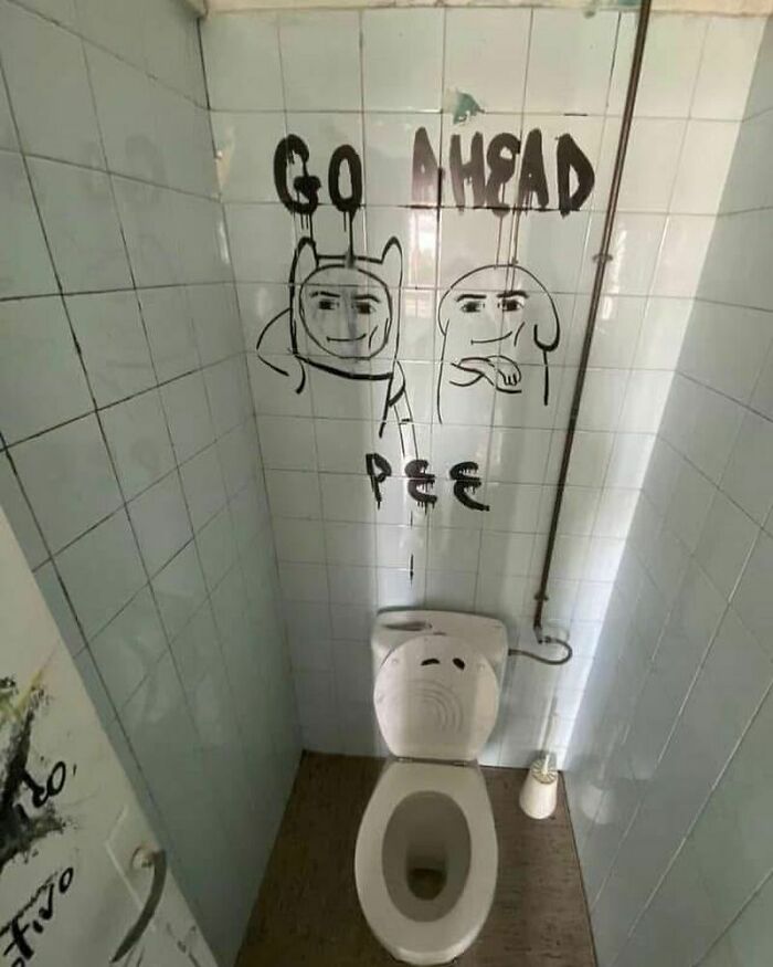 Wall art in a bathroom with humorous doodles above a toilet.