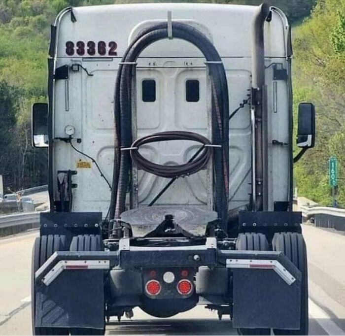 Truck on the highway with a face-like appearance on the rear, showcasing interesting things on the road.