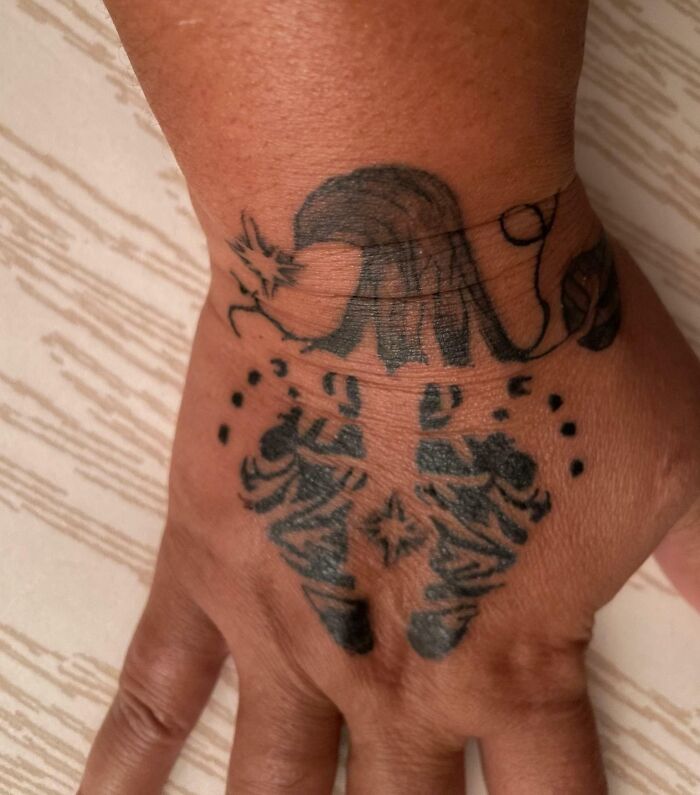 Hand tattoo with intricate design representing amazing mothers-in-law theme.