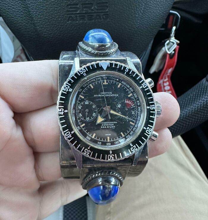 Hand holding a vintage Croton Nivada Grenchen aviator sea diver watch, a unique cool inheritance item.