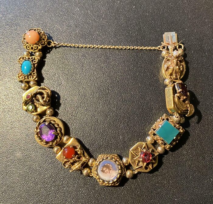 Gold bracelet with colorful gemstones and a vintage portrait charm, a unique inheritance showcasing cool collectible jewelry.