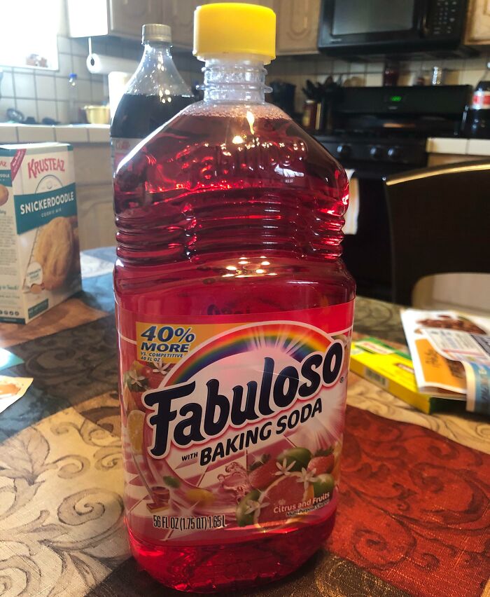 Misleading packaging example of Fabuloso cleaner resembling a beverage bottle with baking soda label in a kitchen setting.
