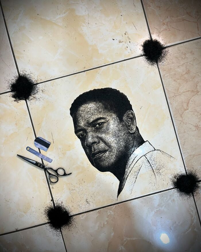 Unique portrait of a man's face created using cut hair by a creative barber, displayed on a tiled floor.
