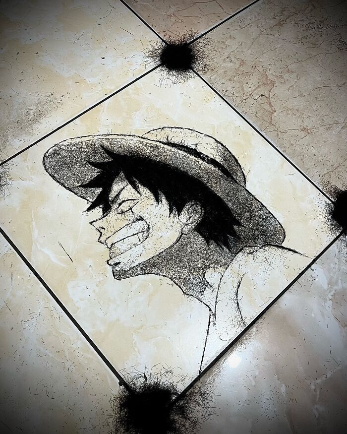 Creative barber's portrait made using cut hair on a tiled floor, showcasing artistic talent and unique style.