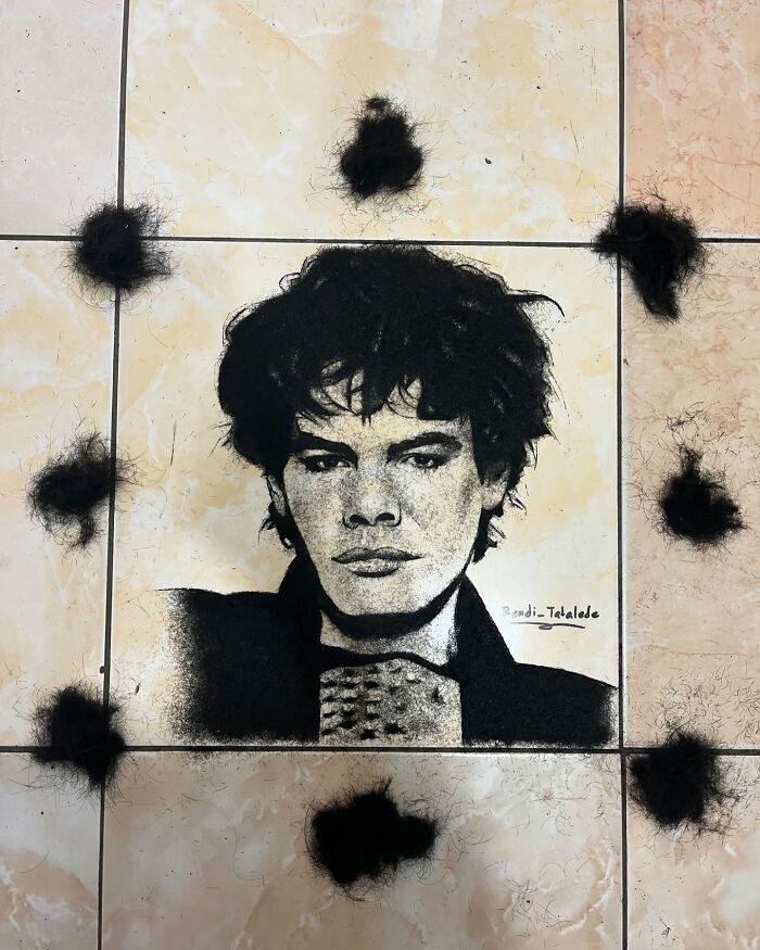 Creative barber portrait using cut hair, depicting a man's face on a tiled floor, showcasing unique artistic skill.