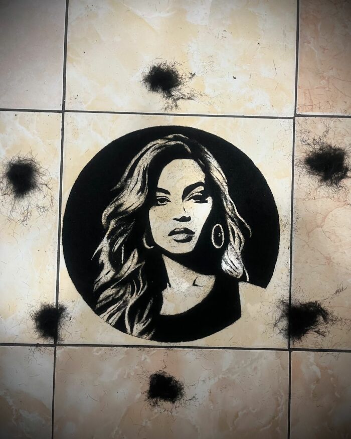 Creative portrait made using cut hair, featuring a stylized image of a woman with flowing hair on a tiled background.