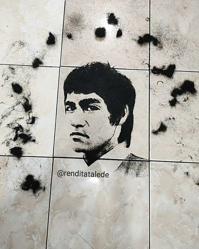 Creative barber portrait made using cut hair, featuring a male figure on tiled floor.