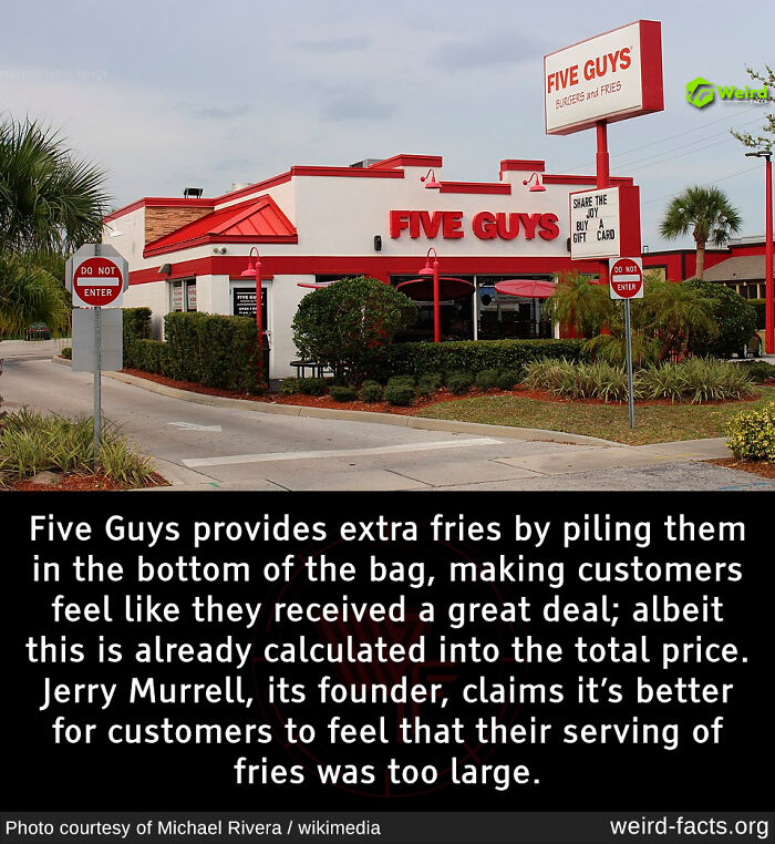 Five Guys restaurant exterior with sign, highlighting a weird fact about their extra fries in the bag strategy.