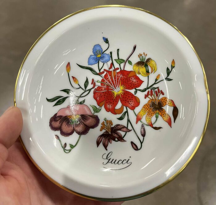 Gucci floral plate found while thrifting, showcasing colorful blossoms and elegant design.