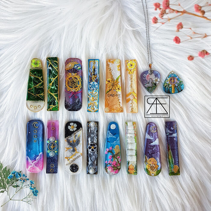 Unique collections of colorful resin art pieces displayed on a white fur background.