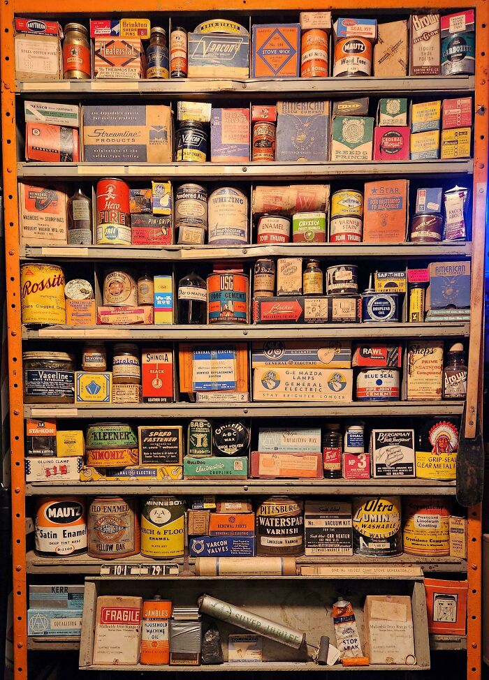 Shelves filled with unexpected unique collections of vintage tins and boxes, showcasing diverse labels and colors.