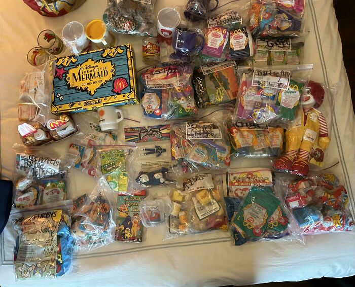 Various vintage fast food toys and memorabilia from an unexpected unique collection spread on a table.