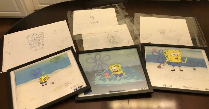 Framed SpongeBob sketches and drawings showcasing unexpected unique collections on a wooden table.