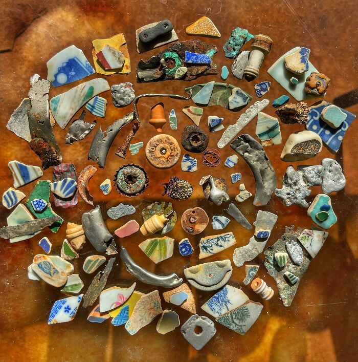 A variety of unexpected unique collections displayed on a surface, including pottery shards and small artifacts.