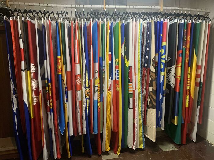 Collection of diverse flags hanging neatly in a wardrobe, showcasing unexpected unique collections.