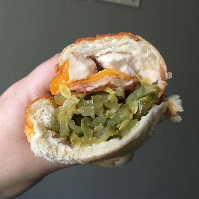 Sandwich with unusual cravings, including pickles and cheese, highlighting funny pregnancy situations.