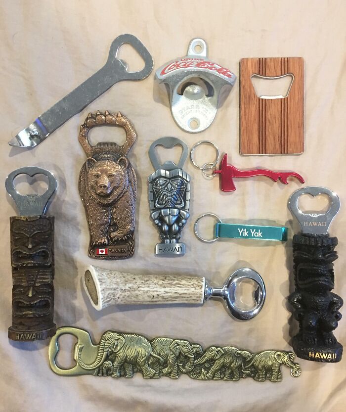 A collection of unique bottle openers featuring various designs, including animals and logos, displayed on a beige background.