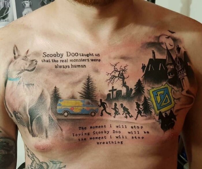 Chest tattoo with Scooby Doo theme, featuring text and haunted scenes, exemplifies funny worst tattoo fails.
