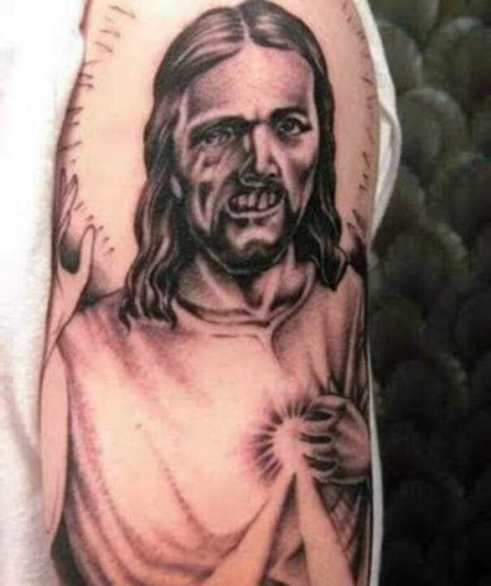 A humorous tattoo fail of a distorted face with long hair and a glowing heart on an arm.