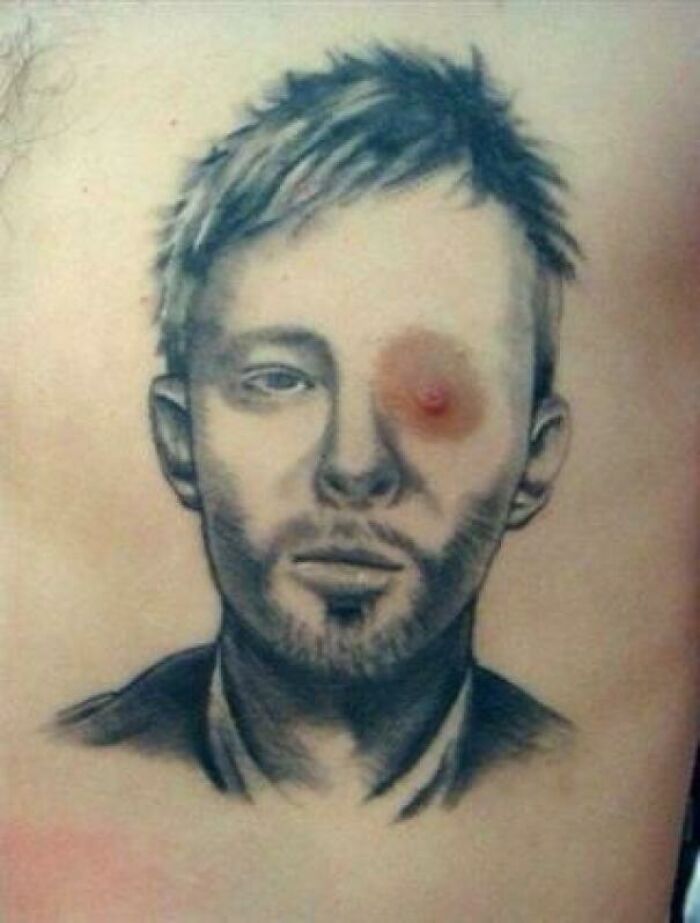 Portrait tattoo with an unfortunate placement creating a funny worst tattoo fail effect.