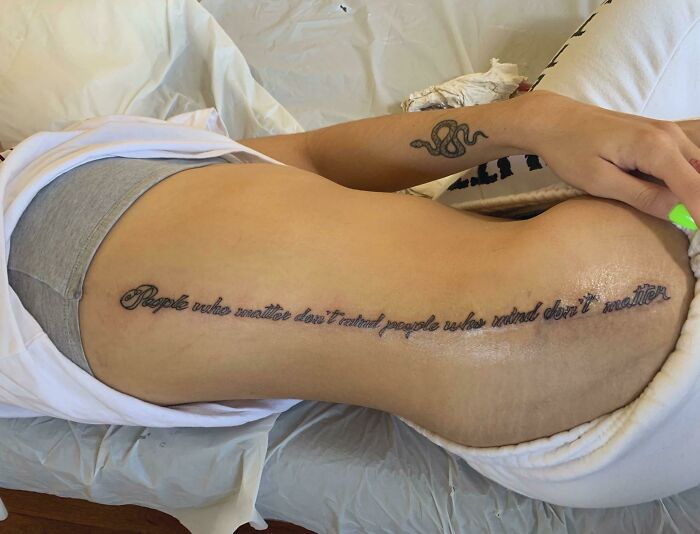 Funny worst tattoo fails example with a misspelled quote on a person's side.