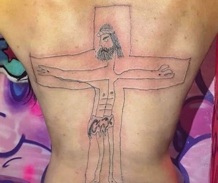 Amateur back tattoo resembling a stick figure on a cross, showcasing a funny worst tattoo fail.