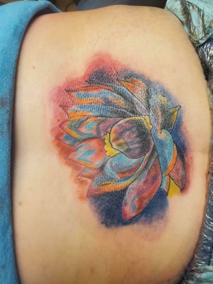 Colorful flower tattoo with awkward shading, an example of tattoo fails.