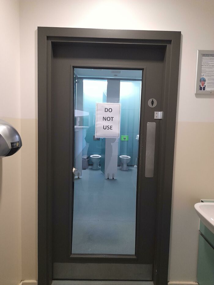 School bathroom with "Do Not Use" sign on door, representing horrifying experiences.