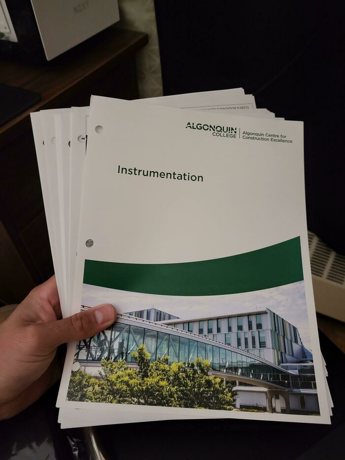 Holding Algonquin College instrumentation booklets, representing school experiences.