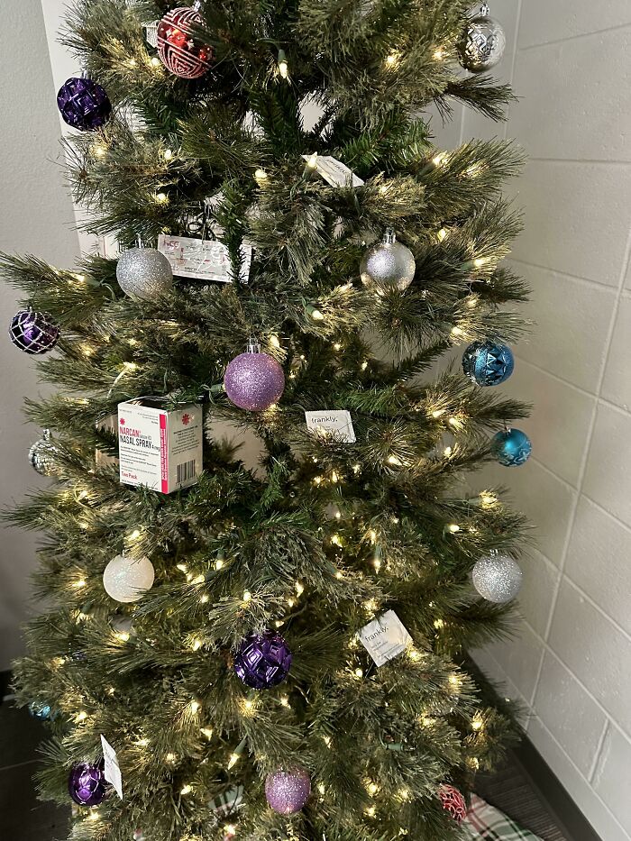 Decorated Christmas tree with colorful ornaments and lights, featuring a creative display with unique items.