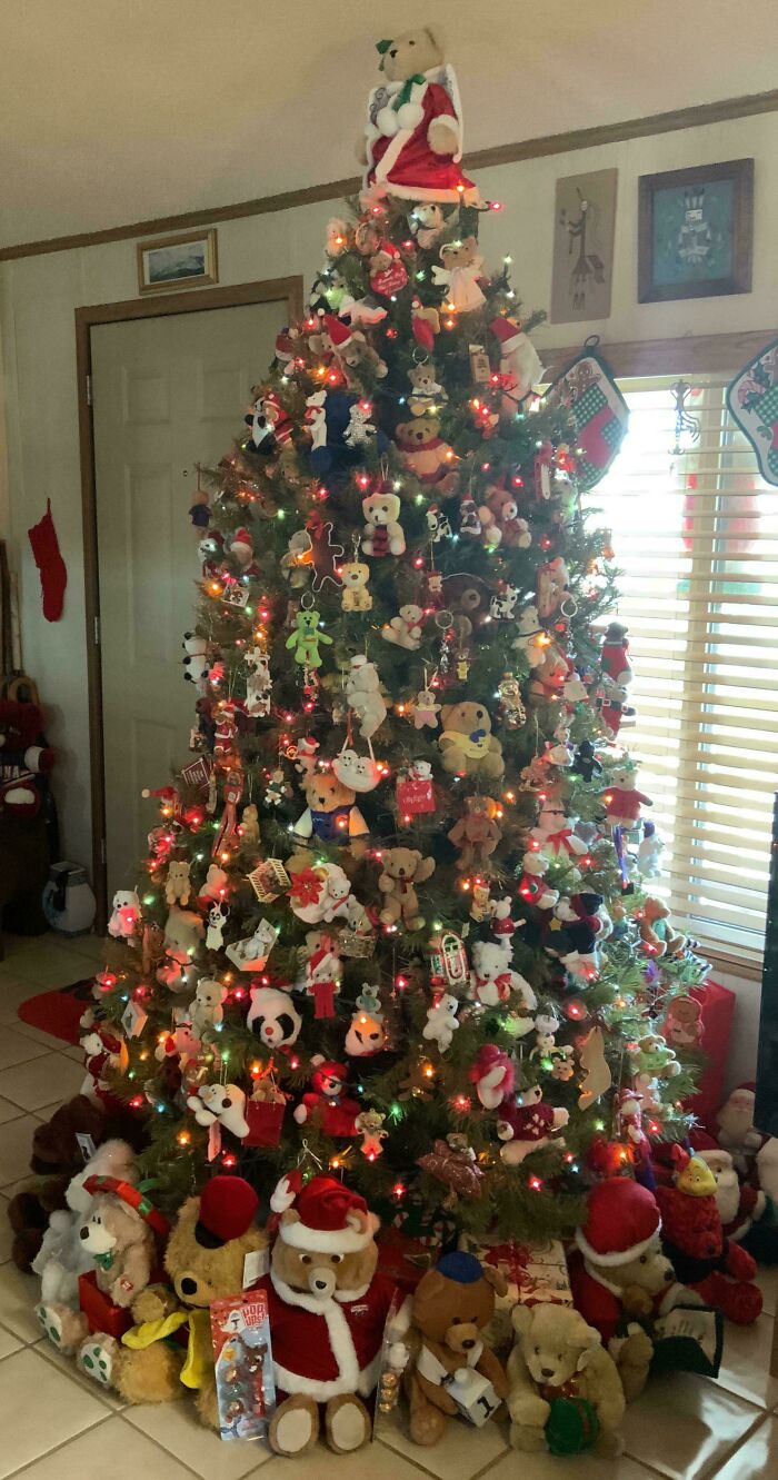 Christmas tree decorated with colorful lights and teddy bear ornaments.