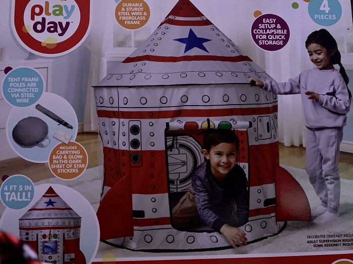Children playing in a rocket-shaped play tent, showcasing a potentially disappointing gift for imaginative play.