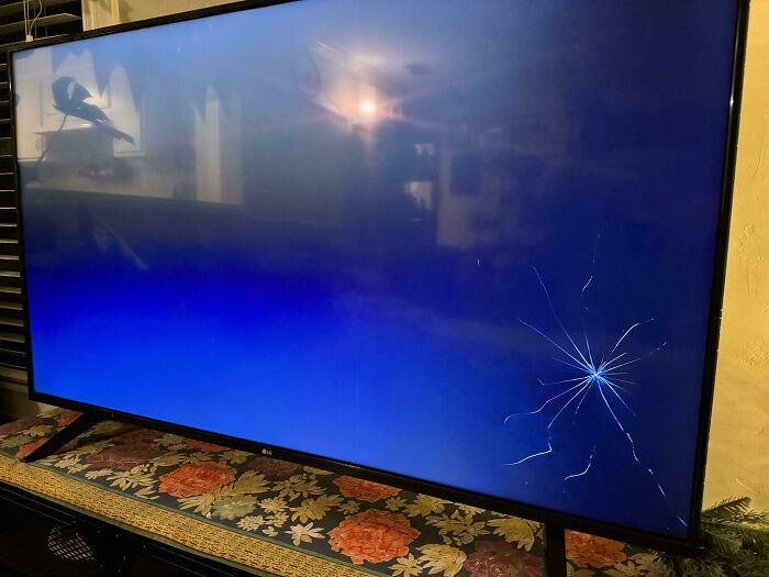A c*****d TV screen highlighting a Christmas accident in a dimly lit room.