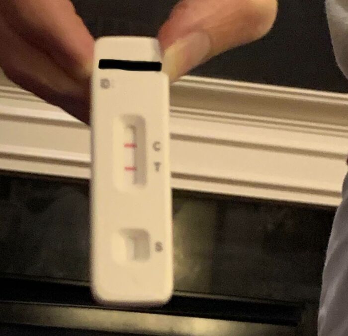 Close-up of a hand holding a pregnancy test, highlighting horrifying US school experiences.