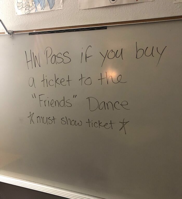 Whiteboard message offering homework pass for buying school dance tickets, hinting at horrifying school experiences.