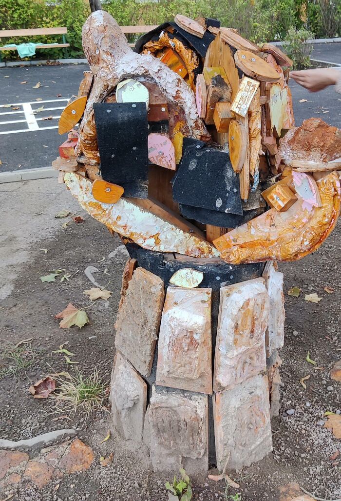 Unusual school art structure showing layers of wood and metal outdoors, related to horrifying US school experiences.