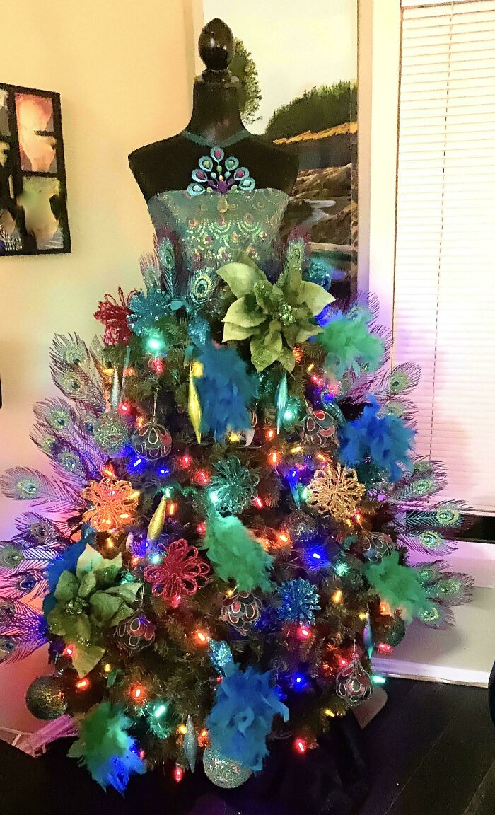 Peacock-themed Christmas tree idea with colorful ornaments and lights.