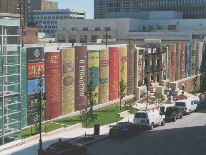 Building designed to look like giant books, showcasing impressive architectural feats in an urban community setting.