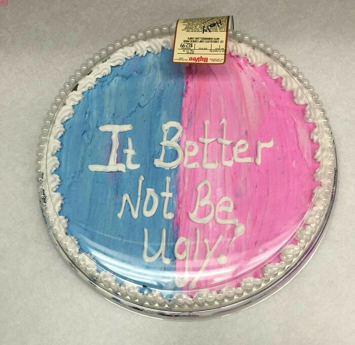 Gender reveal cake with "It Better Not Be Ugly" frosting, highlighting funny pregnancy situations.
